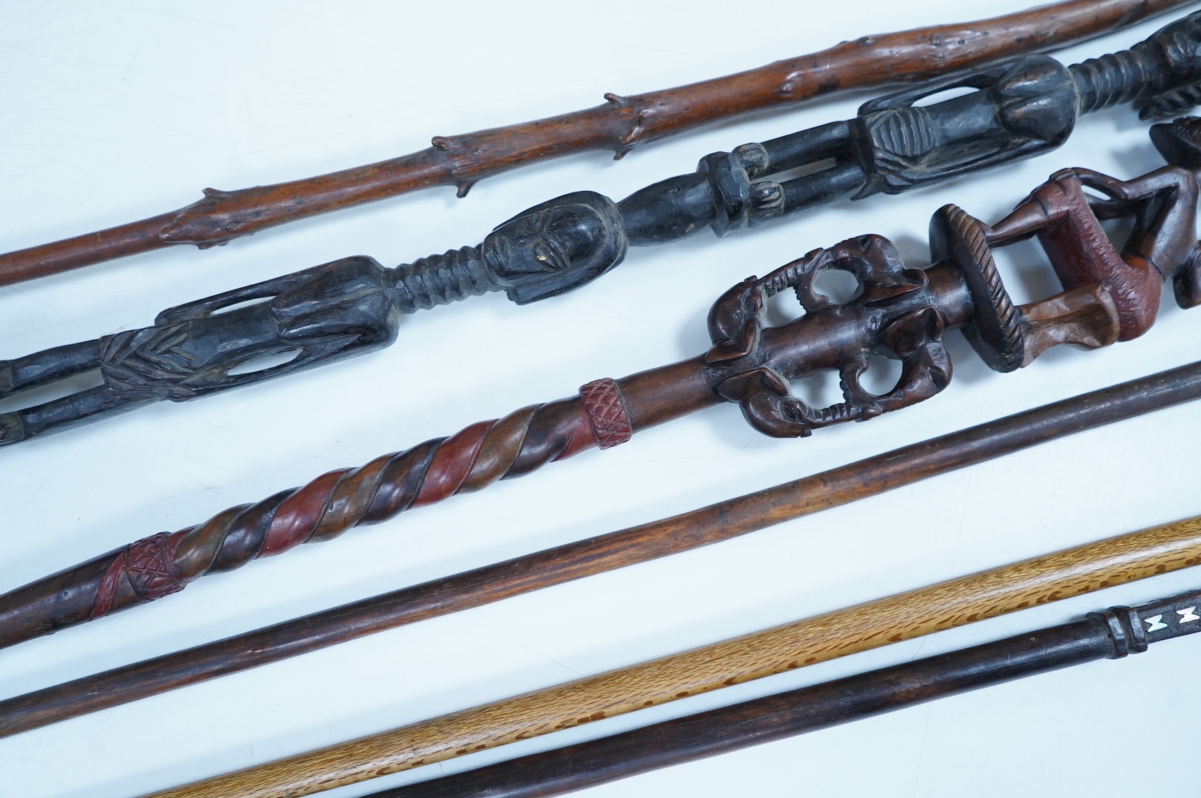 A collection of African and other walking sticks and walking canes - ebonised cane 105 cm long